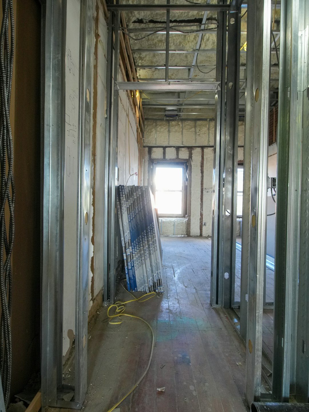 portfolio-07 A three-story brownstone stands in mid-transformation, captured at the raw and honest “before” stage of a full interior renovation. These images document a moment that usually disappears once the walls are closed and the finishes are installed — exposed framing, stripped ceilings, rough staircases, and open corridors that reveal the building’s original structure and hidden history. Light spills in through skylights and tall windows, cutting through layers of dust and unfinished surfaces, creating a quiet contrast between decay and renewal. The space feels both industrial and intimate: narrow