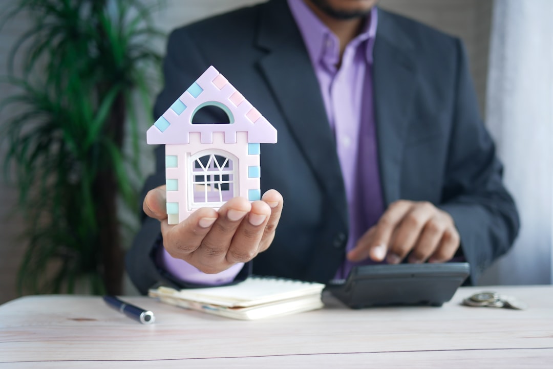services-01 the concept of finance concept , man holding house in hand .
